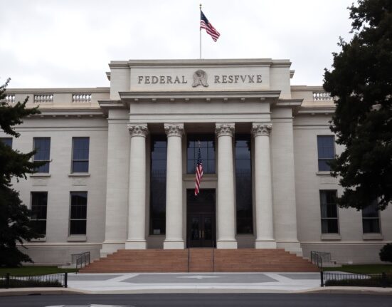 Federal Reserve building in Washington, D.C., on a clear day, symbolizing monetary policy decisions.