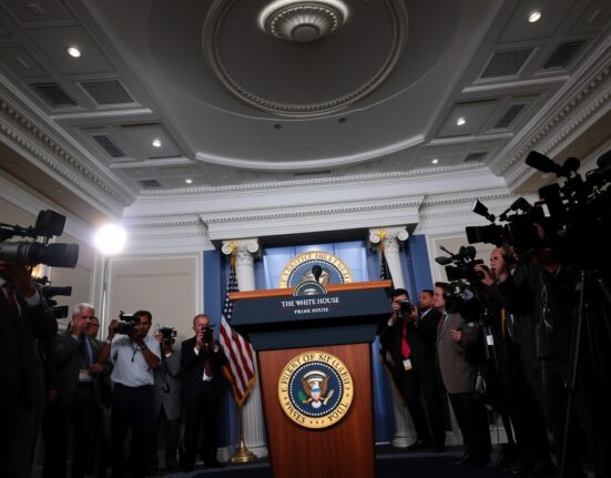 White House press briefing room with presidential podium and journalists.