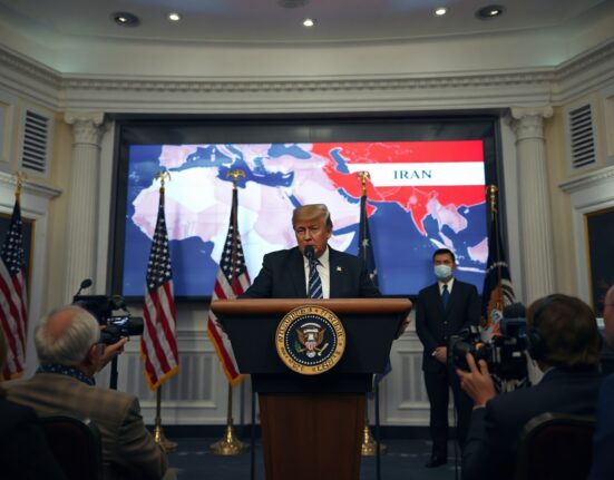 President Trump at White House podium warning of strikes on Iran