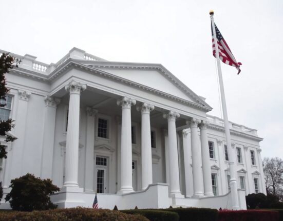 White House exterior on a cloudy day, representing US presidential authority and foreign policy.