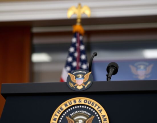 Presidential podium with US flag in background, representing a White House press briefing on foreign policy.