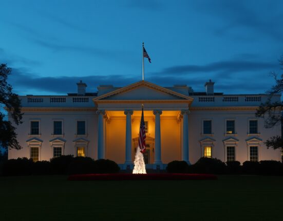 White House illuminated at dusk under a dramatic sky, signaling a major policy announcement.