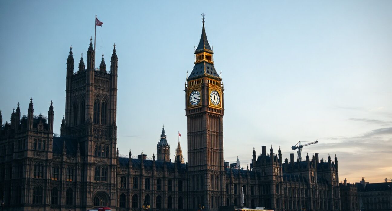 UK Houses of Parliament at dusk with Big Ben in center, symbolizing new political funding laws.