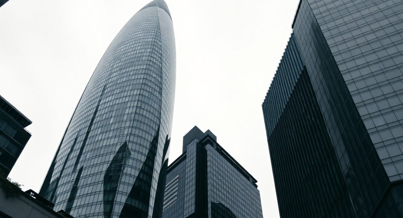 View of the City of London financial district under an overcast sky, representing the UK economy.