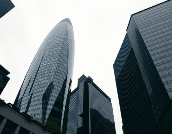 View of the City of London financial district under an overcast sky, representing the UK economy.