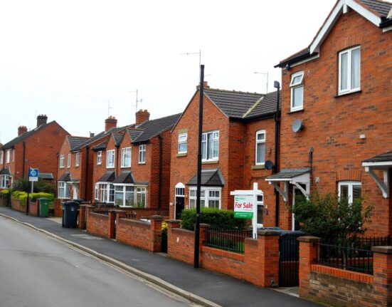 UK residential street with a For Sale sign, representing the housing market in July