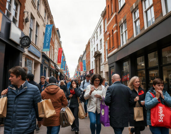 Shoppers on a busy UK high street in July, reflecting retail activity