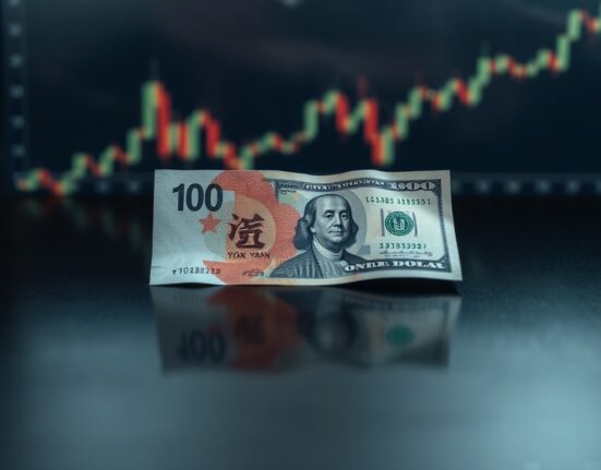Chinese yuan and US dollar banknotes on a reflective surface, symbolizing currency exchange dynamics.
