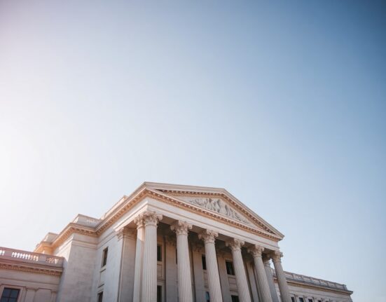 Exterior view of the US Treasury building in Washington, D.C., on a clear day.