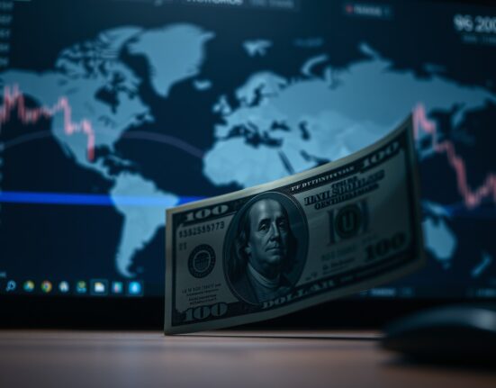 US Dollar banknote in shadow with blurred global chart background representing geopolitical risks