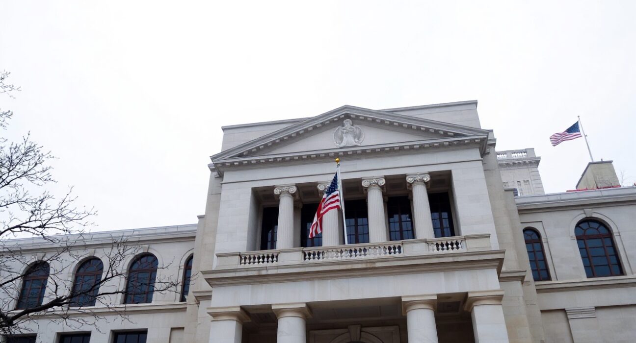 Exterior of the Federal Reserve building in Washington, D.C., on a cloudy day.