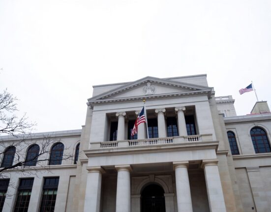 Exterior of the Federal Reserve building in Washington, D.C., on a cloudy day.