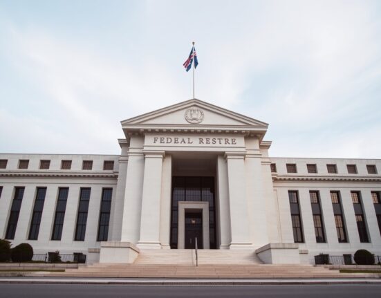 Federal Reserve building in Washington D.C. on a cloudy day, representing monetary policy uncertainty.