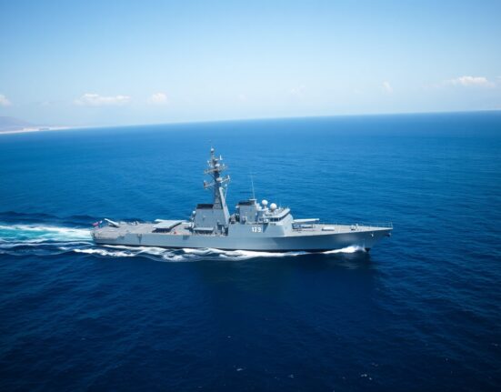 U.S. Navy destroyer enforcing maritime blockade on Iran in the strategic Strait of Hormuz.