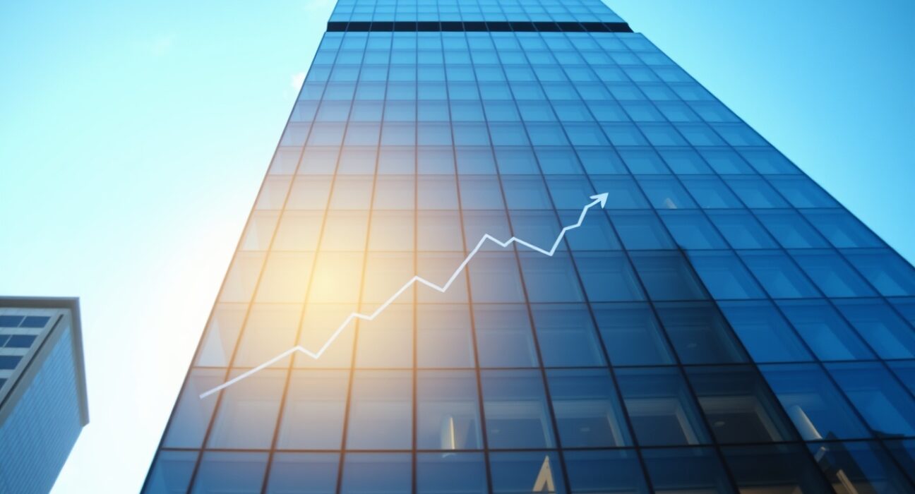 Modern office building in a US city reflecting a clear blue sky, symbolizing steady economic growth.