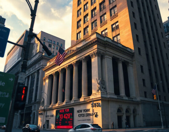 New York Stock Exchange building facade on a sunny afternoon with red and green ticker lights