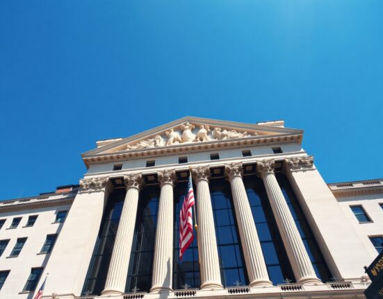 The New York Stock Exchange building with the American flag flying on a clear day, symbolizing the stock market's record-breaking rally.