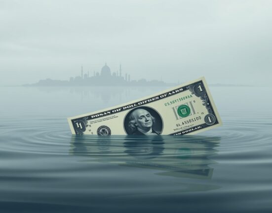 US dollar banknote partially submerged in water with distant war-torn city skyline, representing USD liquidity backstops under geopolitical war pressures.