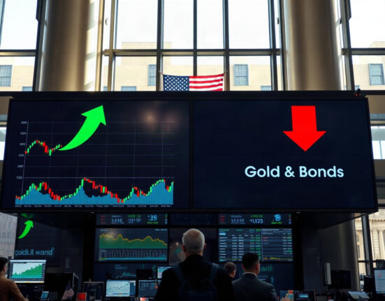 Trading floor display showing mixed market movements after Fed comments