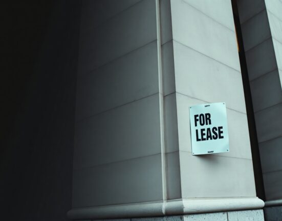 Federal Reserve building with a 'For Lease' sign, symbolizing weak labor market and economic slowdown
