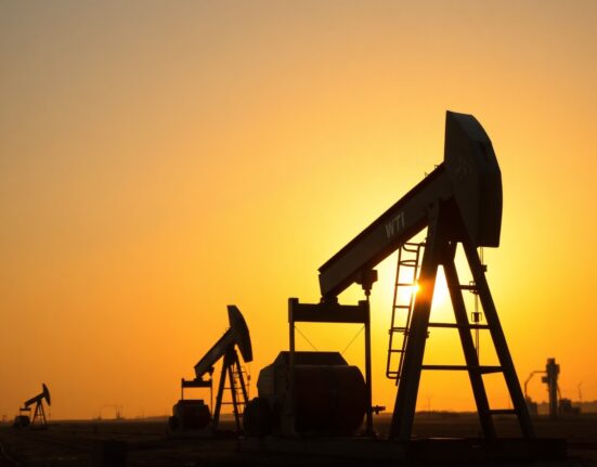 WTI crude oil pumpjack in an oil field at sunset, representing energy supply and market movements.
