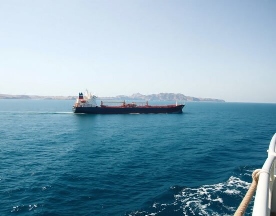 Oil tanker sailing through the Strait of Hormuz under clear skies