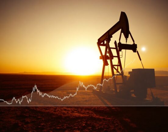 Oil pumpjack silhouette at sunset with financial chart overlay showing rising WTI crude oil price.