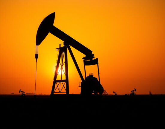 Oil pumpjack in field at sunset with Middle East map overlay