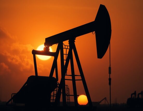 Oil pumpjack silhouetted against a sunset sky, representing crude oil price volatility amid geopolitical tensions.