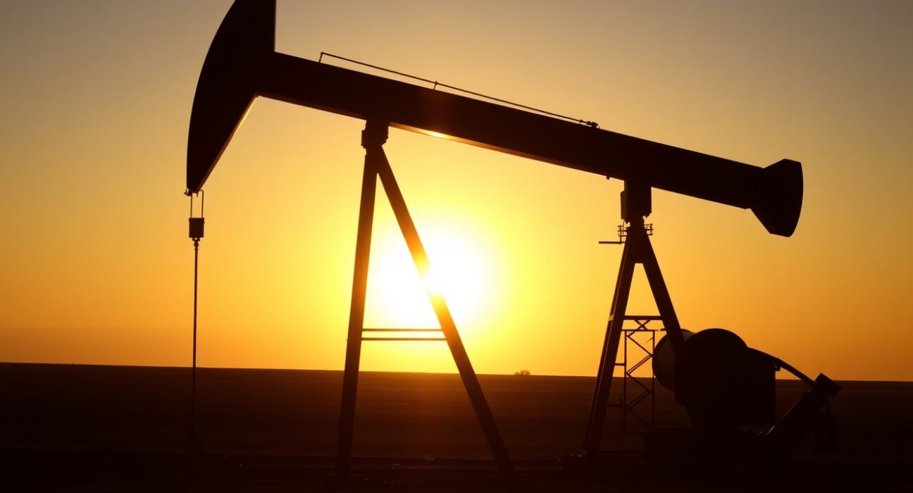 Oil pumpjack silhouette at sunset representing steady crude oil markets