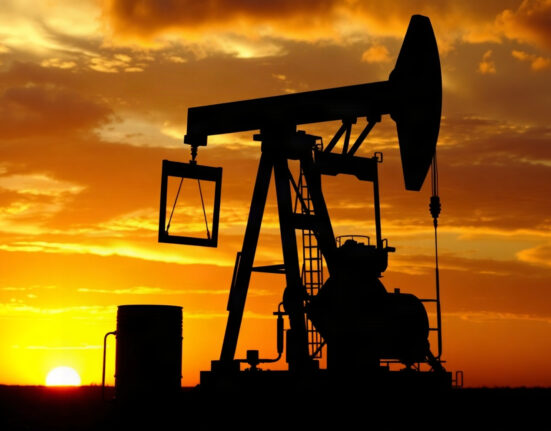 Oil pump jack in an oil field at sunset, representing WTI crude oil market movements