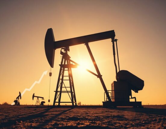 Oil pumpjack silhouetted against sunset sky, symbolizing falling WTI crude oil prices amid Middle East peace hopes.