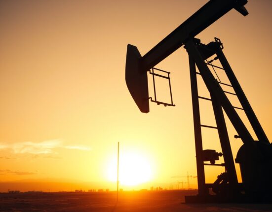 Oil pumpjack silhouetted against a sunset sky in an oil field, representing WTI crude oil price movements.