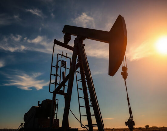 WTI oil pumpjack silhouette at sunset, representing crude oil market movements amid Iran tensions.