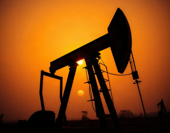 Oil pump jack silhouetted against a sunset sky, representing rising crude oil prices due to geopolitical tensions.