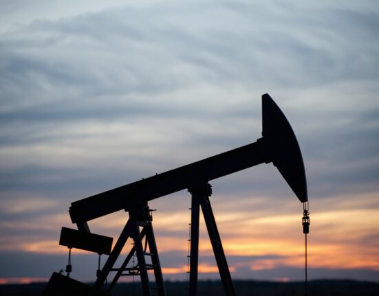 WTI crude oil pumpjack silhouette at dusk with bearish market outlook