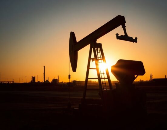 Crude oil pumpjack silhouetted against sunset sky representing WTI price movements and energy market analysis