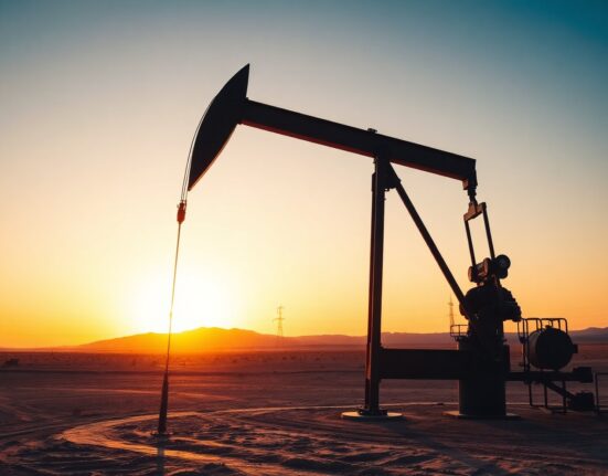 Crude oil pumpjack silhouetted at sunset in desert oil field, representing WTI supply dynamics