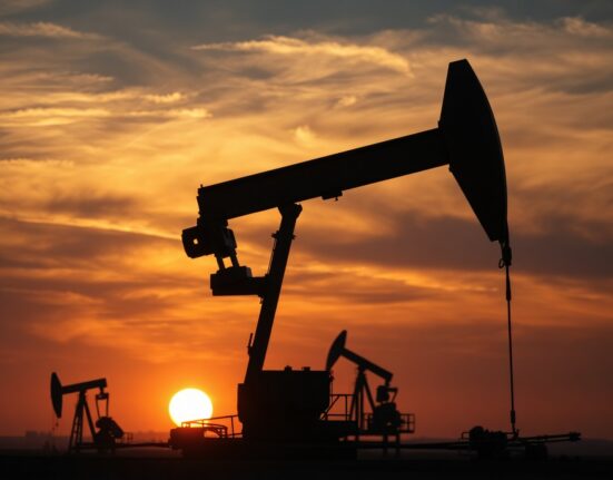 Oil pumpjack silhouette at sunset with WTI price forecast context