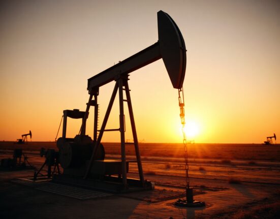 Oil pumpjack in a field at sunset, representing WTI crude supply and market conditions.