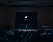Apple Park WWDC 2026 keynote stage with Apple Intelligence and Siri AI graphics on screen