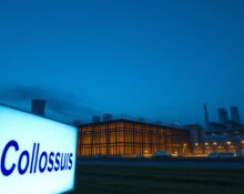 Exterior view of xAI's Colossus 1 data center at dusk, showing the scale of the facility.