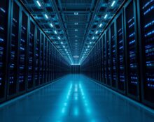 Interior of a large AI data center with rows of servers and blue lighting, representing xAI's Colossus compute infrastructure.