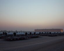 Aerial view of natural gas turbines on trailers at an xAI data center in Mississippi, with hazy sky.