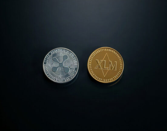 XRP and XLM digital tokens on a dark surface, symbolizing support levels and market analysis