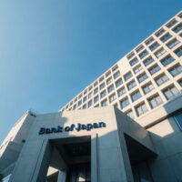 Bank of Japan headquarters in Tokyo on a clear day, symbolizing monetary policy and yen strength.