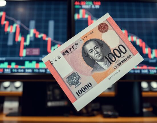 Japanese yen banknote with forex trading chart in background